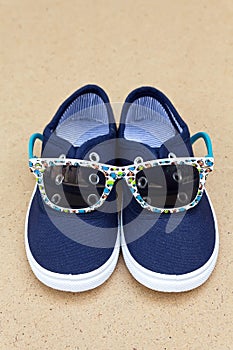 Blue sneakers and sunglasses. Summer holidays