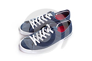 Blue sneakers on white background with copy space. Youth shoes
