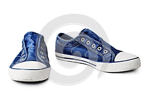 Blue sneakers on white background isolated close up, stylish rubber gumshoes without laces, pair of sport denim shoes