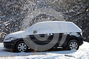 Blue snow-covered and frozen car.