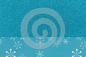 Blue snowflakes on glitter material holiday background