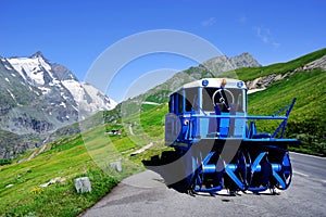Blue snowplow in a parking on the Grossglockner High Alpine Road in summer time..