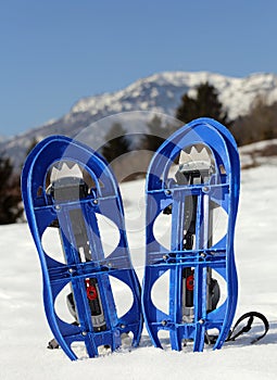 Blue snowshoes in the mountain