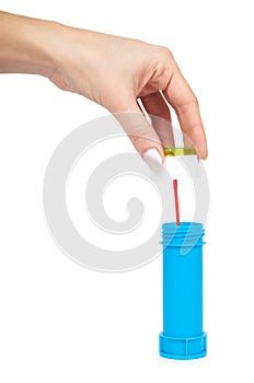 Blue soap bubble bottle with hand isolated on white background