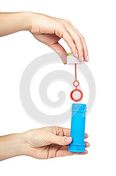 Blue soap bubble bottle with hand isolated on white background