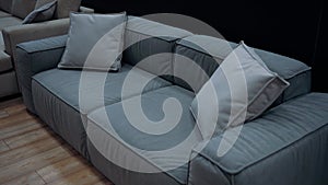 Blue sofa with gray cushions, slow shot from above. 4k video.