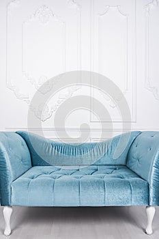 Blue sofa in white interior and gray floor. Venetian style