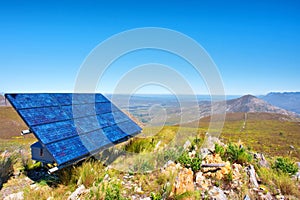 Blue solar cells against awesome mountain landscape