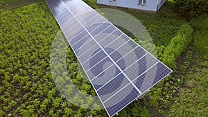 Blue solar panels for clean energy on green grass.