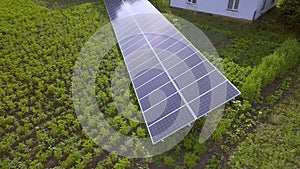 Blue solar panels for clean energy on green grass.