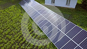 Blue solar panels for clean energy on green grass.