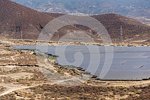 Blue solar panels at photovoltaics power station farm, future innovation energy concept, clear blue sky background