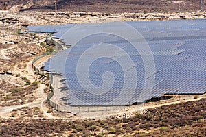 Blue solar panels at photovoltaics power station farm, future innovation energy concept, clear blue sky background