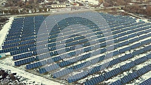 Blue solar photo voltaic panels system producing renewable clean energy in rural area in winter.