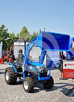 Blue Solis tractor with front loader at exhibition