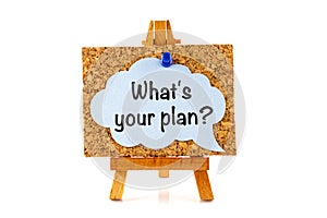 Blue speech bubble with phrase What`s your plan? on corkboard on