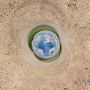 Blue sphere little planet inside gravel road or field background. curvature of space