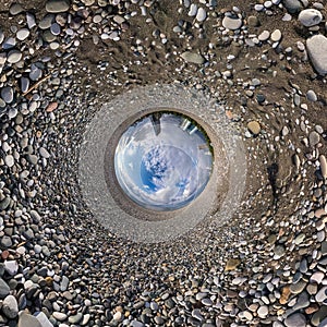 Blue sphere little planet inside gravel road and pebbles. curvature of space