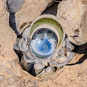 Blue sphere little planet inside gravel road and pebbles. curvature of space