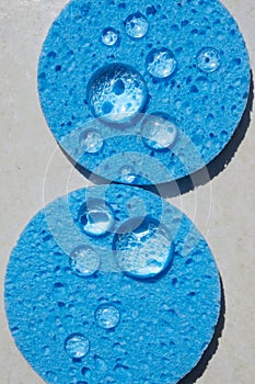 Blue sponge close up with water drops. Face Cleansing and Make Up Removing Beauty Routine