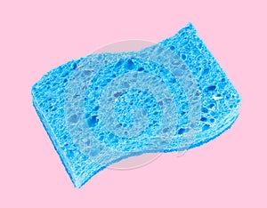 Blue sponge on pastel pink background