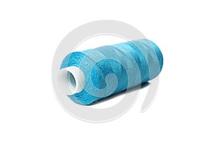 Blue spool of thread isolated on white background