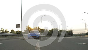 Blue sport car driving on the city highway