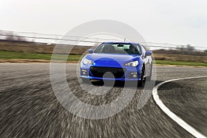 Blue sport car on race way