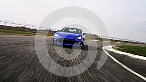 Blue sport car on race way