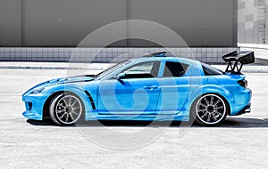 Blue sport car on race way. Closeup capture.