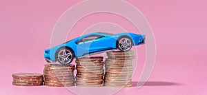 Blue sporty car with stacked coins.