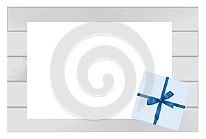 Blue Square Gift Box with Blue Bow on Wooden Plank Background with White sheet of paper.