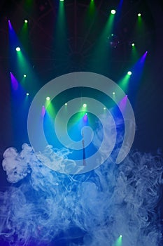 Blue stage circus smoke and green beams from projectors