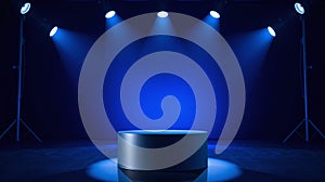 A blue stage lit by focused beams of light