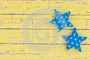 Blue stars on rustic wood background for a Christmas greeting card