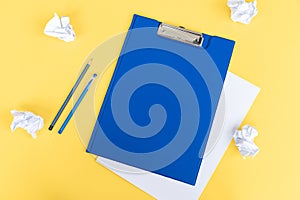 A blue stationery set as a template with a place to copy on a yellow background. Crumpled paper