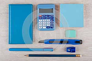 Blue stationery tools on light wooden table