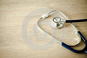 A blue stethoscope on the desk.