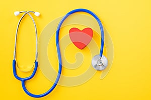 Blue stethoscope with red heart, medical care design concept