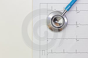 Blue stethoscopes and  Electrocardiography  chart close up image