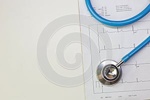 Blue stethoscopes and  Electrocardiography  chart close up image photo