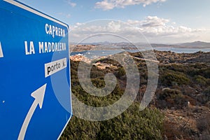 Blue street sign giving direction to Caprera and La Maddalena