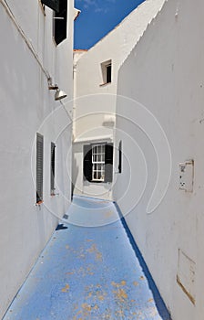 Blue street between white houses, Minorca, Spain