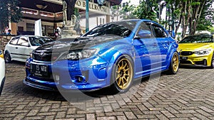 Blue Subaru WRX STI in a car meet