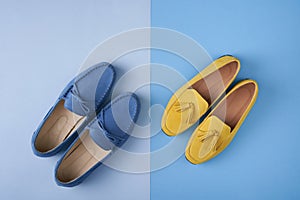 Blue suede man`s and yellow woman`s moccasins shoes over blue background
