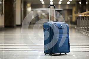 Blue suitcase at airport