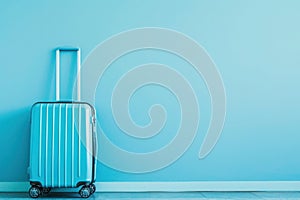 a blue suitcase is leaning against a blue wall