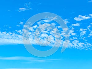 Blue Summer Sky with Scattered Soft White Clouds