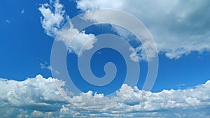 Blue summer sky with thick thunderstorm clouds moving across. Dark grey storm clouds. Time lapse.