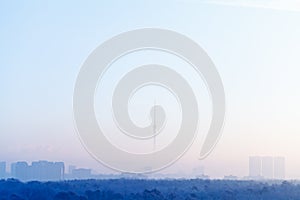 Blue sunrise sky over city and TV tower in winter